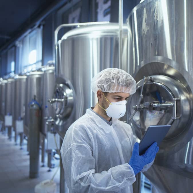 employee inspecting food container